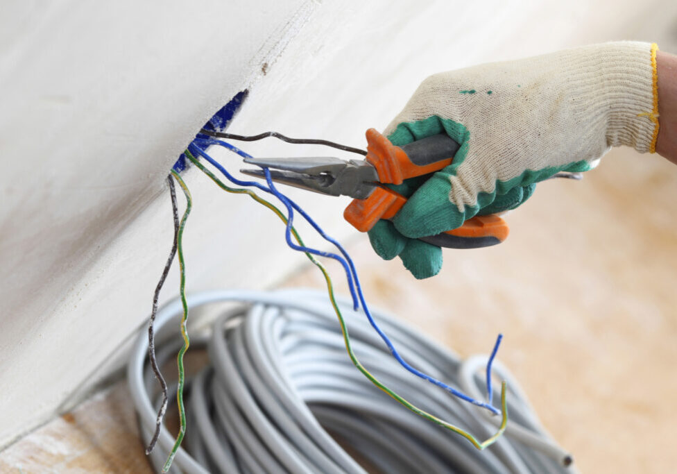 a person holding a pair of scissors and wires